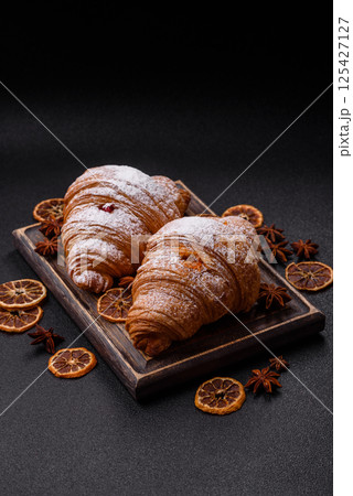 Sweet fresh crispy croissant with fruit filling 125427127