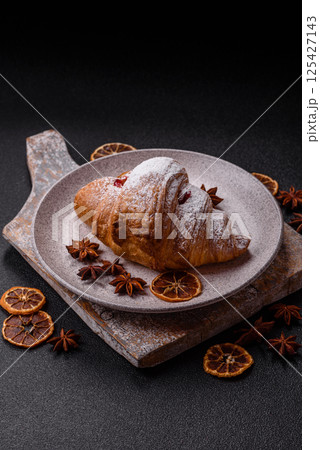 Sweet fresh crispy croissant with fruit filling Sweet fresh crispy croissant with fruit filling 125427143