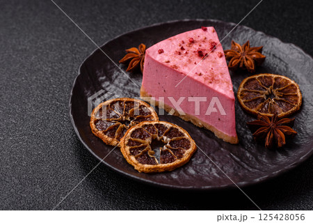 A piece of sweet cheesecake with raspberry or strawberry flavor 125428056