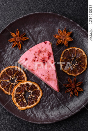A piece of sweet cheesecake with raspberry or strawberry flavor A piece of sweet cheesecake with raspberry or strawberry flavor 125428058