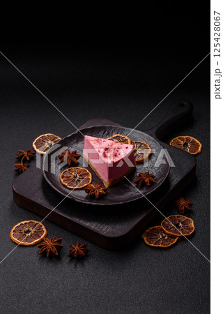 A piece of sweet cheesecake with raspberry or strawberry flavor A piece of sweet cheesecake with raspberry or strawberry flavor 125428067