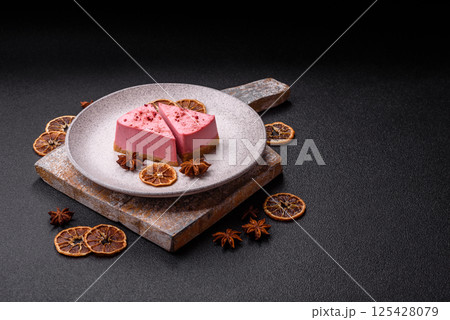A piece of sweet cheesecake with raspberry or strawberry flavor A piece of sweet cheesecake with raspberry or strawberry flavor 125428079