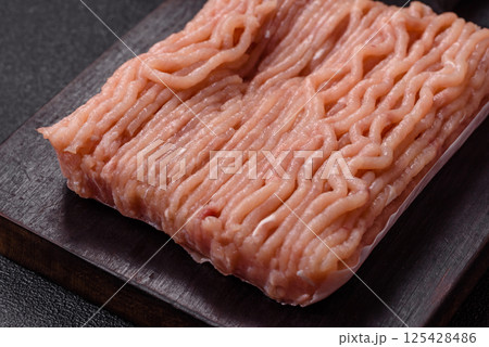Raw minced chicken with salt, spices and herbs 125428486
