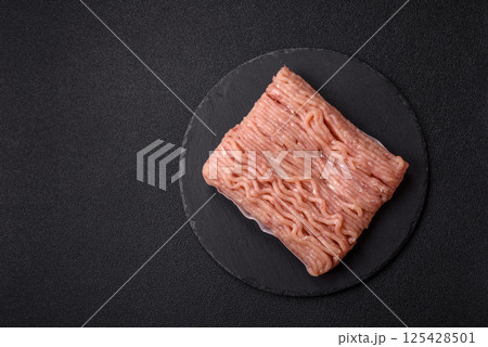 Raw minced chicken with salt, spices and herbs Raw minced chicken with salt, spices and herbs 125428501