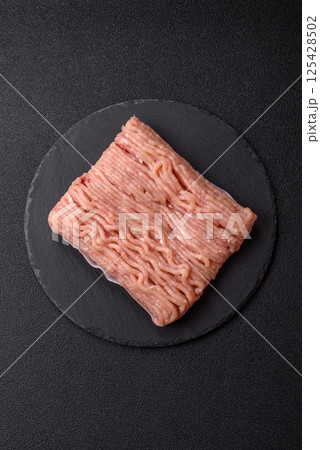 Raw minced chicken with salt, spices and herbs Raw minced chicken with salt, spices and herbs 125428502