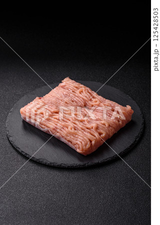 Raw minced chicken with salt, spices and herbs 125428503