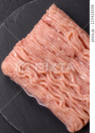 Raw minced chicken with salt, spices and herbs 125428506