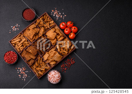 Crispy homemade brown bread chips with seeds and grains Crispy homemade brown bread chips with seeds and grains 125428545