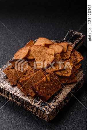 Crispy homemade brown bread chips with seeds and grains Crispy homemade brown bread chips with seeds and grains 125428568