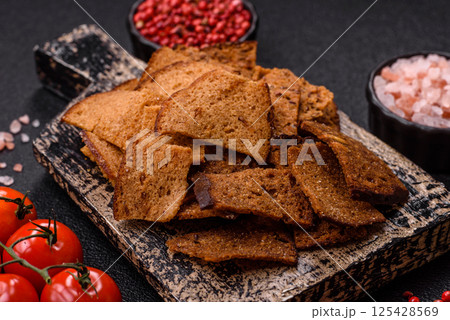 Crispy homemade brown bread chips with seeds and grains Crispy homemade brown bread chips with seeds and grains 125428569