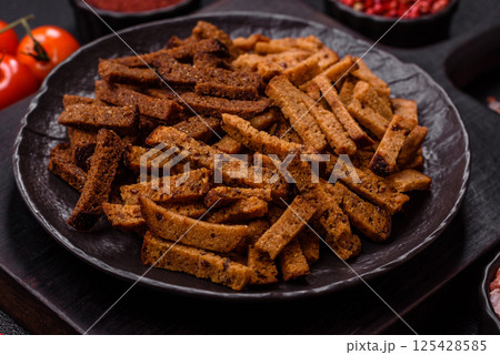 Crispy homemade brown bread crackers or croutons with seeds and grains 125428585