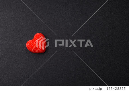Red wax candle in the shape of a heart as decor for Valentine's Day 125428825