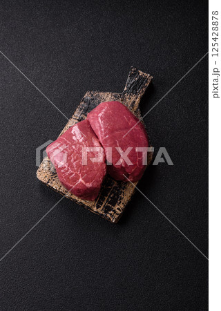 Raw beef tenderloin ribeye steak with salt and spices Raw beef tenderloin ribeye steak with salt and spices 125428878