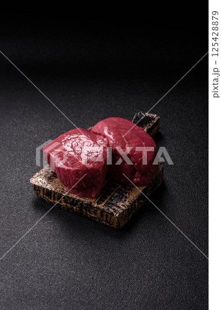 Raw beef tenderloin ribeye steak with salt and spices Raw beef tenderloin ribeye steak with salt and spices 125428879