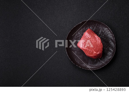 Raw beef tenderloin ribeye steak with salt and spices Raw beef tenderloin ribeye steak with salt and spices 125428893