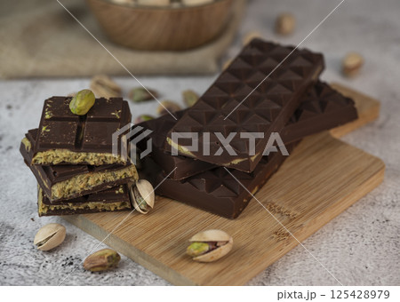 Delicious chocolate bar with pistachio pieces showcased in a Dubai setting, perfect for dessert 125428979