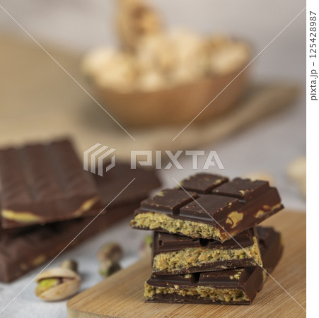 Delicious chocolate bar with pistachio pieces showcased in a Dubai setting, perfect for dessert Delicious chocolate bar with pistachio pieces showcased in a Dubai setting, perfect for dessert 125428987