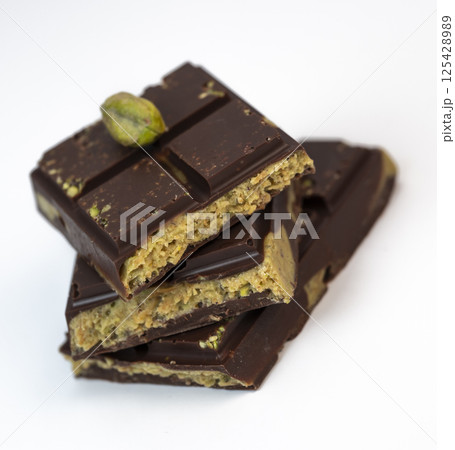 Delicious kadaif layers with rich chocolate and pistachio topping displayed on a clean, white Delicious kadaif layers with rich chocolate and pistachio topping displayed on a clean, white 125428989