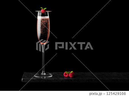 Elegant glass of pink rose champagne with raspberry on stick with fresh berries and mint leaf Elegant glass of pink rose champagne with raspberry on stick with fresh berries and mint leaf 125429108