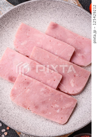 Delicious canned pink ham with salt, spices and herbs 125429212