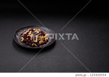 Mixture of roasted cashews and dried cranberries Mixture of roasted cashews and dried cranberries 125429354