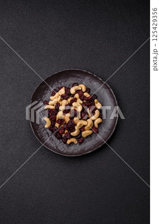 Mixture of roasted cashews and dried cranberries Mixture of roasted cashews and dried cranberries 125429356