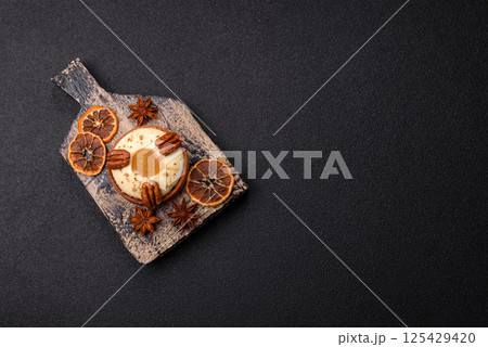 Sweet round tart with white citrus cream and pecans 125429420