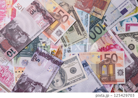 A background consisting of paper banknotes of different currencies 125429703