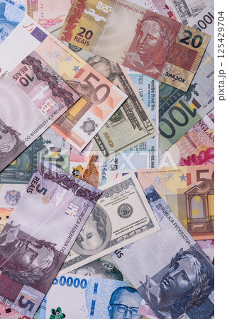 A background consisting of paper banknotes of different currencies 125429704