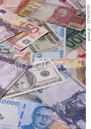 A background consisting of paper banknotes of different currencies A background consisting of paper banknotes of different currencies 125429705