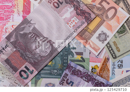 A background consisting of paper banknotes of different currencies 125429710