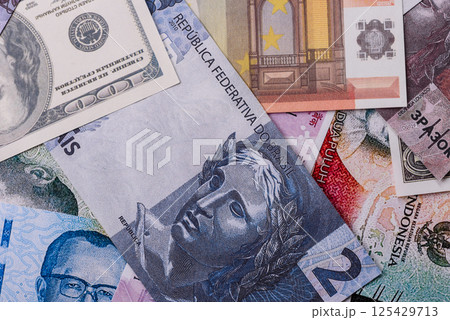 A background consisting of paper banknotes of different currencies 125429713