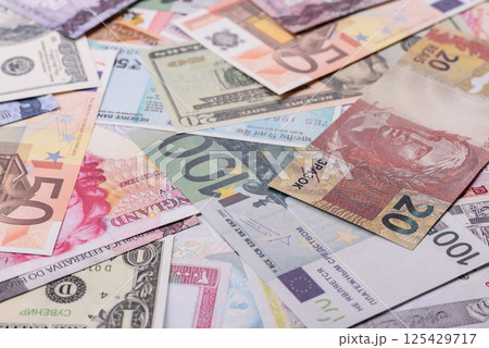 A background consisting of paper banknotes of different currencies A background consisting of paper banknotes of different currencies 125429717