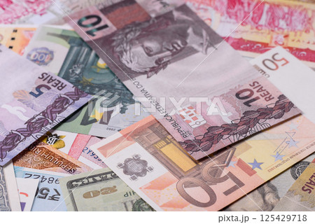 A background consisting of paper banknotes of different currencies A background consisting of paper banknotes of different currencies 125429718