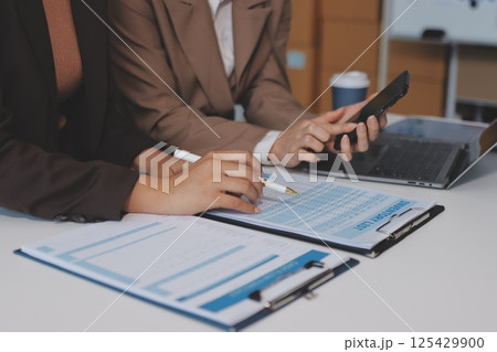 Accounting company provide finance and taxation planning for profitable cash flow, Auditor and accountant team working in office, analyze financial data and accounting record with calculator.Insight 125429900