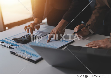 Accounting company provide finance and taxation planning for profitable cash flow, Auditor and accountant team working in office, analyze financial data and accounting record with calculator.Insight 125429902