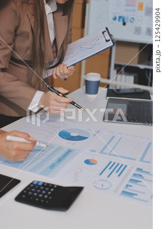 Accounting company provide finance and taxation planning for profitable cash flow, Auditor and accountant team working in office, analyze financial data and accounting record with calculator.Insight 125429904