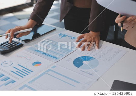 Accounting company provide finance and taxation planning for profitable cash flow, Auditor and accountant team working in office, analyze financial data and accounting record with calculator.Insight Accounting company provide finance and taxation planning for profitable cash flow, Auditor and accountant team working in office, analyze financial data and accounting record with calculator.Insight 125429905