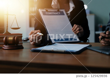 Judge gavel with Justice lawyers having team meeting at law firm background. Concepts of Law and Legal services. Judge gavel with Justice lawyers having team meeting at law firm background. Concepts of Law and Legal services. 125429936