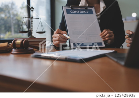 Judge gavel with Justice lawyers having team meeting at law firm background. Concepts of Law and Legal services. 125429938