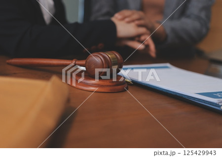 Judge gavel with Justice lawyers having team meeting at law firm background. Concepts of Law and Legal services. Judge gavel with Justice lawyers having team meeting at law firm background. Concepts of Law and Legal services. 125429943