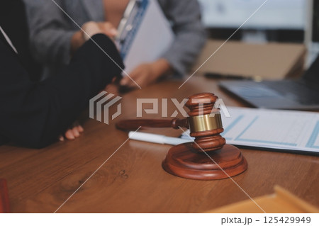 Judge gavel with Justice lawyers having team meeting at law firm background. Concepts of Law and Legal services. Judge gavel with Justice lawyers having team meeting at law firm background. Concepts of Law and Legal services. 125429949