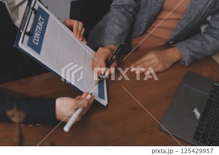Judge gavel with Justice lawyers having team meeting at law firm background. Concepts of Law and Legal services. 125429957