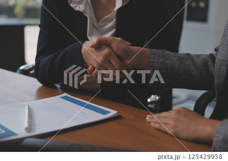 Judge gavel with Justice lawyers having team meeting at law firm background. Concepts of Law and Legal services. 125429958