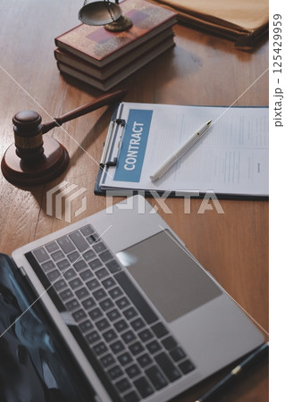 Judge gavel with Justice lawyers having team meeting at law firm background. Concepts of Law and Legal services. 125429959