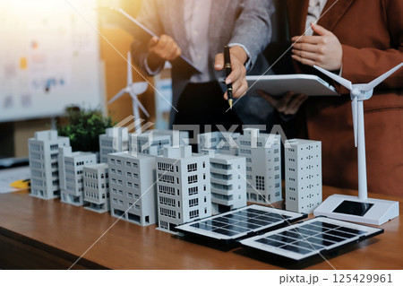 Discussion among businesspeople on the latest developments in solar cell panel technology and Solar Energy Environment city Concept. 125429961