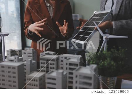 Discussion among businesspeople on the latest developments in solar cell panel technology and Solar Energy Environment city Concept. 125429966