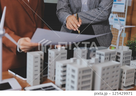 Discussion among businesspeople on the latest developments in solar cell panel technology and Solar Energy Environment city Concept. 125429971