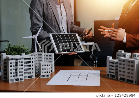 Discussion among businesspeople on the latest developments in solar cell panel technology and Solar Energy Environment city Concept. 125429984