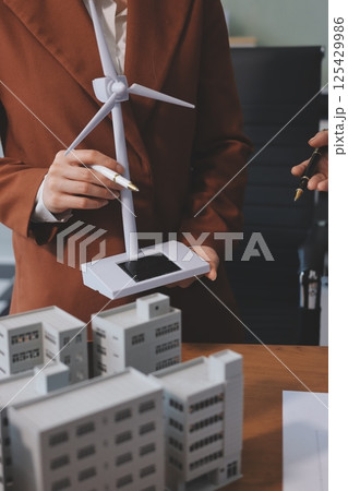 Discussion among businesspeople on the latest developments in solar cell panel technology and Solar Energy Environment city Concept. Discussion among businesspeople on the latest developments in solar cell panel technology and Solar Energy Environment city Concept. 125429986